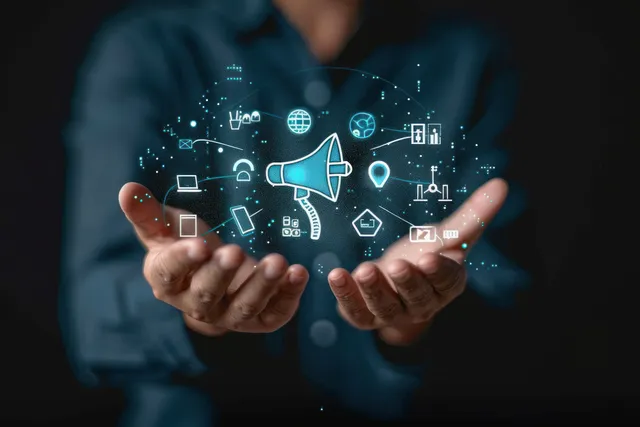 Hands presenting glowing holographic megaphone amid digital communication icons and network signals