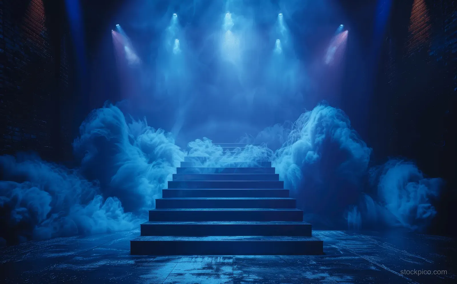 Blue spotlights shine on a dark staircase stage surrounded by thick smoke in a concert-like club scene.