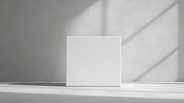 Minimal white cube gift box on light gray studio surface