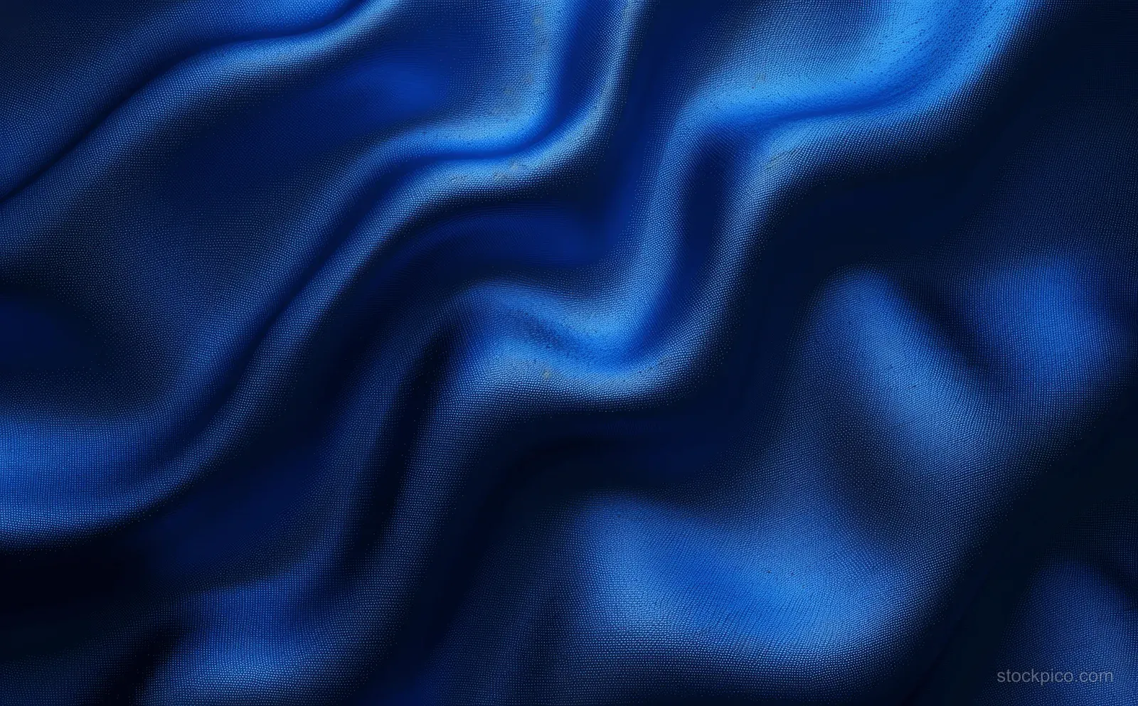 Navy blue satin waves with soft folds and a subtle metallic sheen.