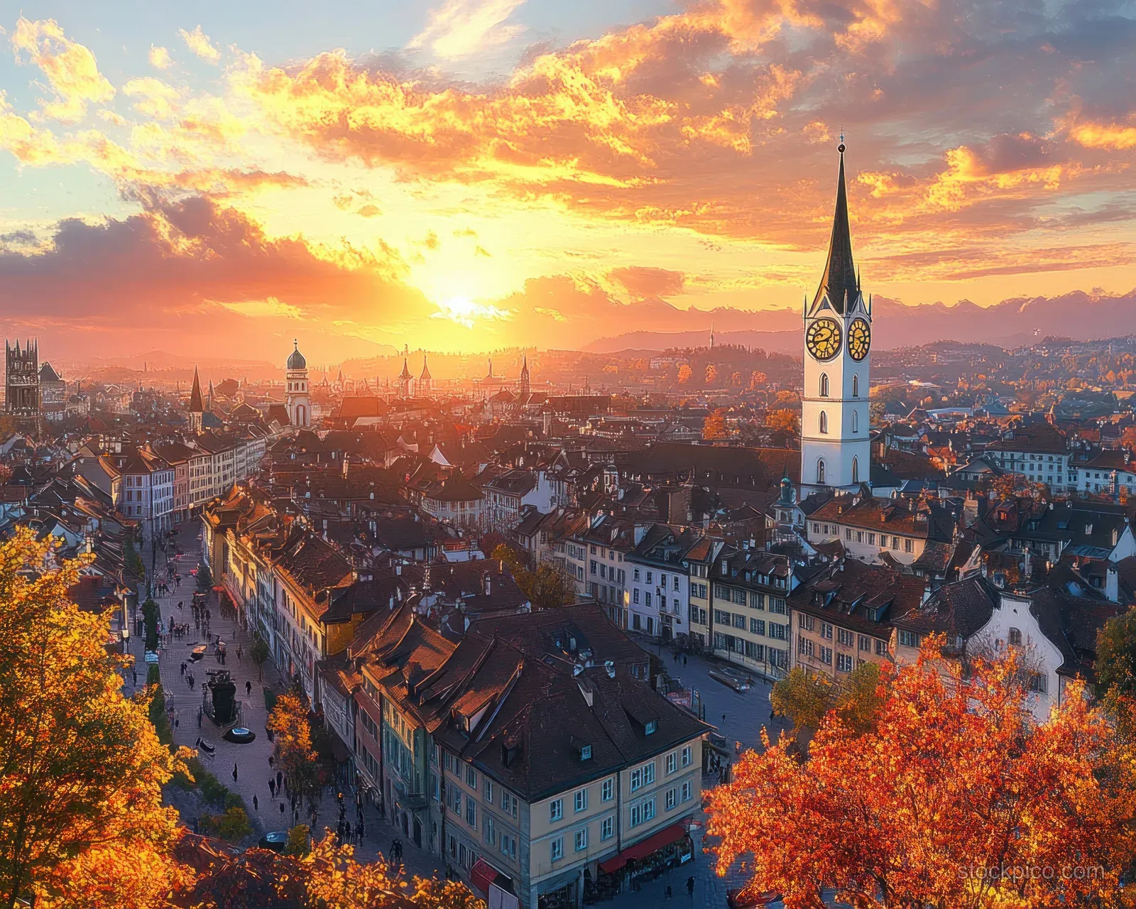 Aerial view of Zurich Old Town at sunset with a tall clock tower and autumn-colored buildings.