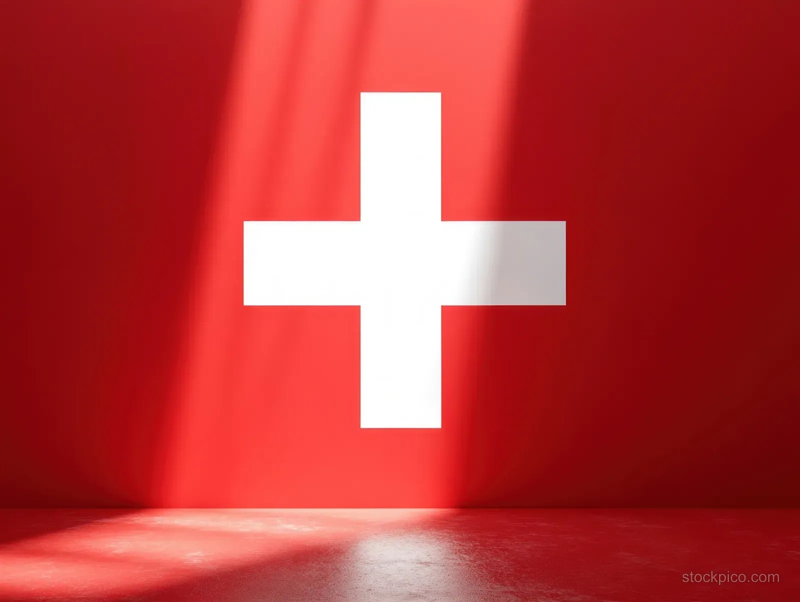 A white cross symbol is centered on a red wall with light casting shadows across a smooth red floor.