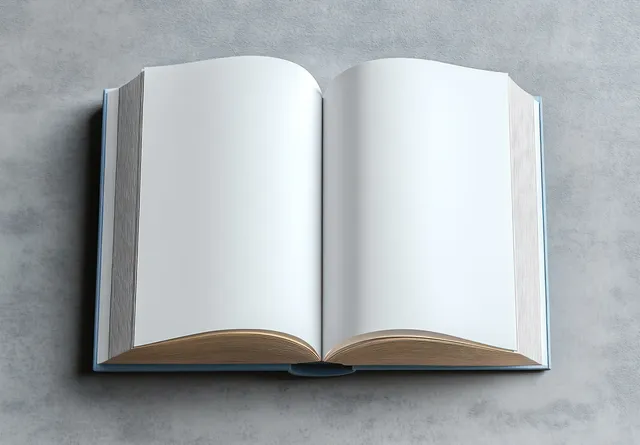 An open book with blank pages on a gray textured background under soft studio lighting.