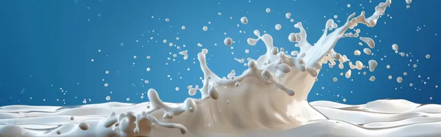 Milk splash pouring white liquid against blue background with crisp droplet motion