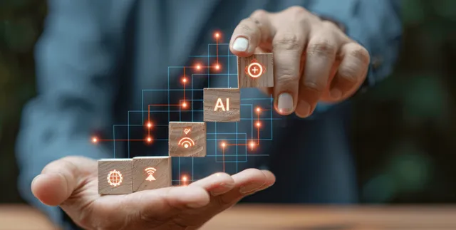 A businessman’s hands tap a glowing holographic AI interface with linked network and cybersecurity icons.