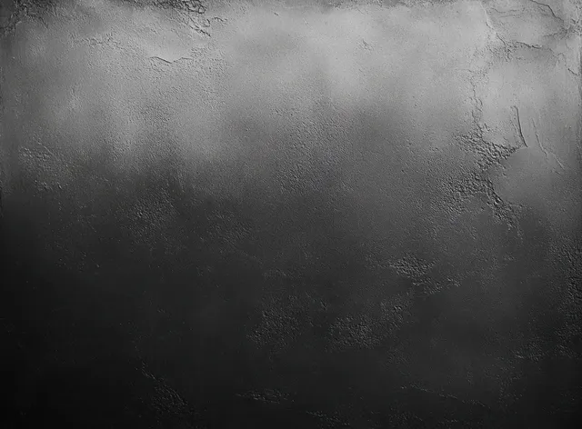 Rough black wall texture with gradient lighting and subtle concrete grain close-up