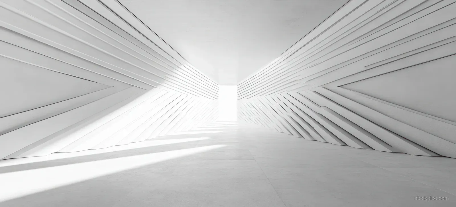 Minimalist white hallway interior with angular geometric wall lines and bright light from an open doorway casting sharp shadows.