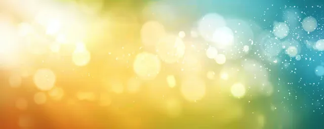 Warm golden and cool blue bokeh lights with drifting sparkles
