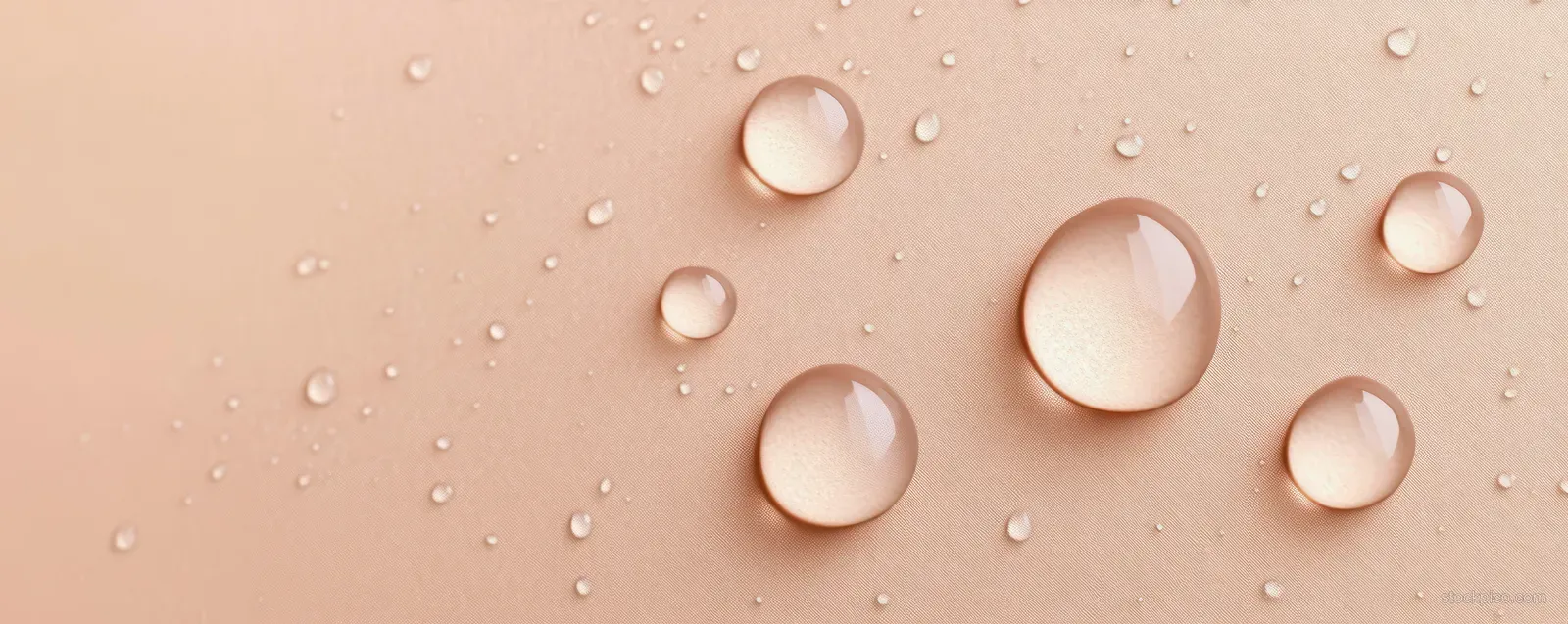 Transparent gel drops and glossy moisturizer beads on a neutral beige background with tiny bubbles.