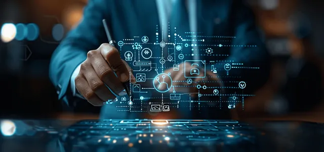 An HR manager types on a keyboard with holographic HR and talent management icons floating over the desk.
