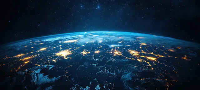 Earth from space at night with glowing city lights across continents beneath a starry background.