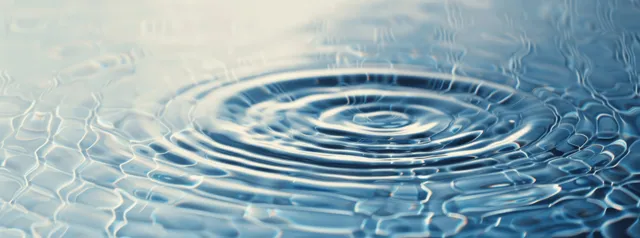 Sunlight shimmering water ripples with soft blue texture, panoramic copy space background