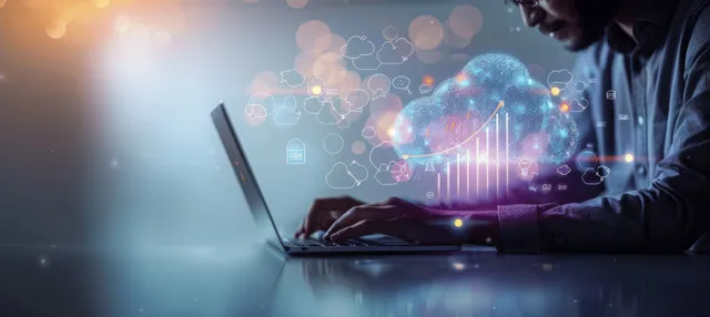 An office worker uses a laptop while floating cloud network graphics display data transfer and storage analytics.