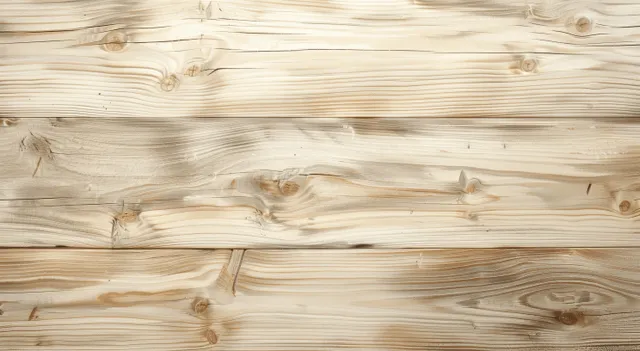 Beige white pine tabletop viewed from above showing light grain knots and plank seams