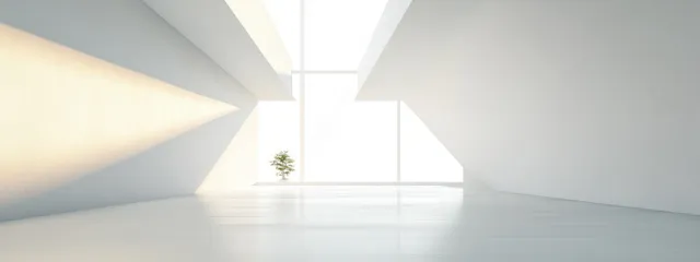 White minimalist interior corridor with geometric ceiling beams and bright natural light from windows.
