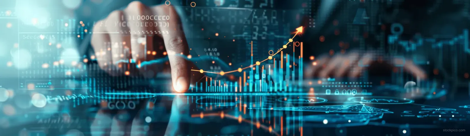 A businessman points at rising financial charts on a glowing digital screen.