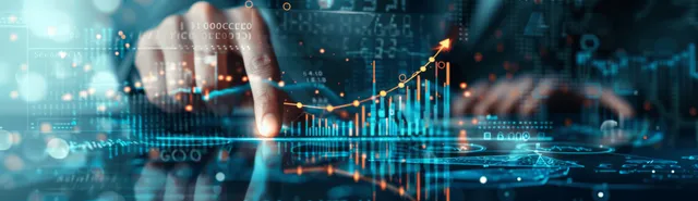 A businessman points at rising financial charts on a glowing digital screen.