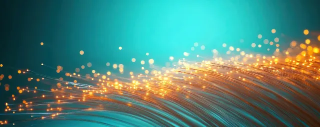 Glowing orange fiber optic lines streaming across a blue abstract background