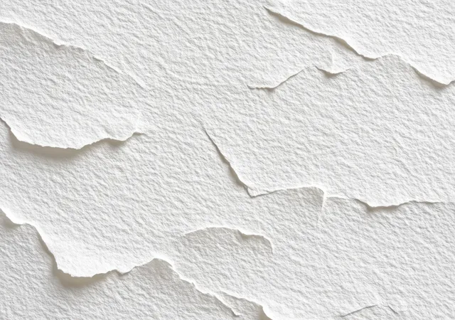 White torn paper layers overlap in a close-up, revealing rough edges and textured fibers.