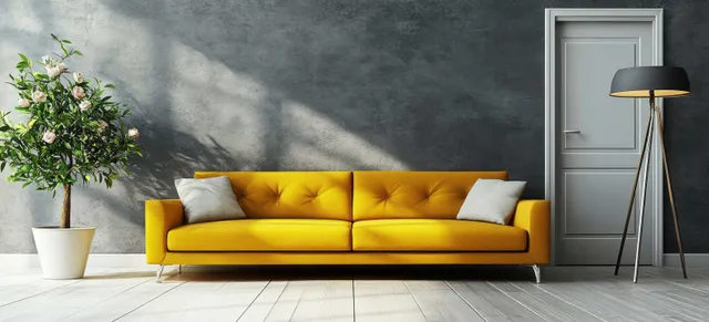 Bright yellow sofa in minimalist grey living room with floor lamp and floral vase