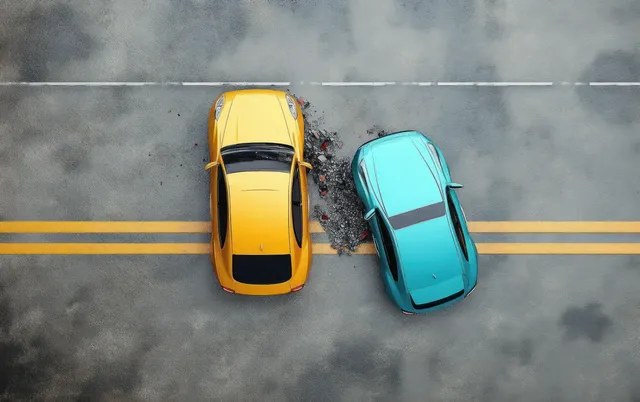Top view of a yellow and blue car facing damage after a side collision on a double yellow lined road.