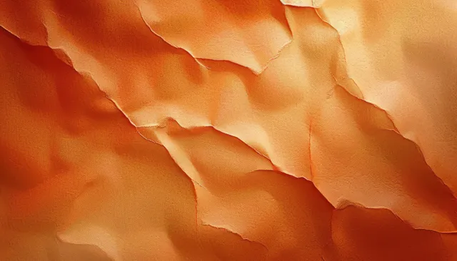 Torn orange paper layers forming a textured abstract warm background