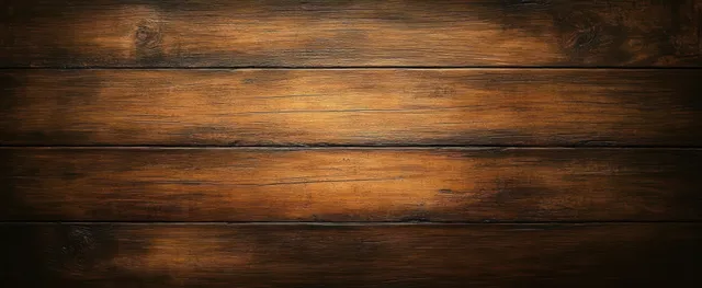 Close-up of dark polished wooden planks with warm low lighting showing visible wood grain and reflections.