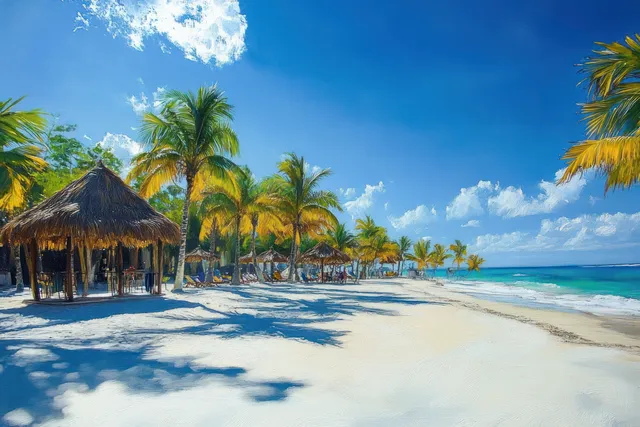 Sunny tropical beach with palm trees, thatched umbrellas, and turquoise ocean under blue sky