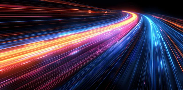 Neon light trails streak through a dark futuristic tunnel with motion blur