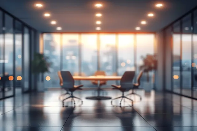Blurred modern office meeting area with round table, panoramic windows, and warm ceiling lights with Lighting And Ambience