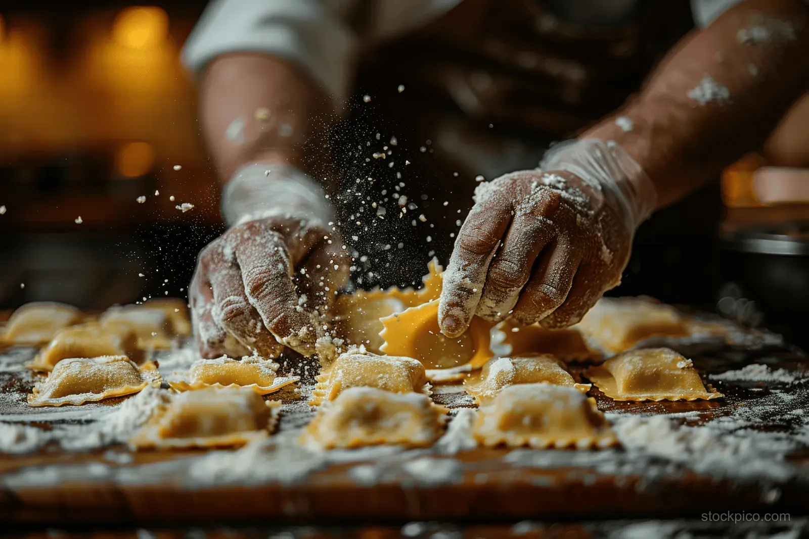 Gloved hands shape and seal pierogi dumplings on a floured countertop during a cooking class.