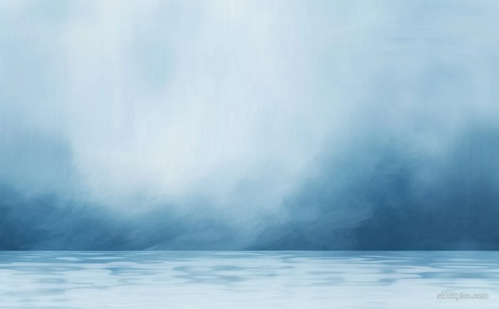 Smooth water reflects a misty blue sky beneath soft, layered clouds and a quiet horizon.