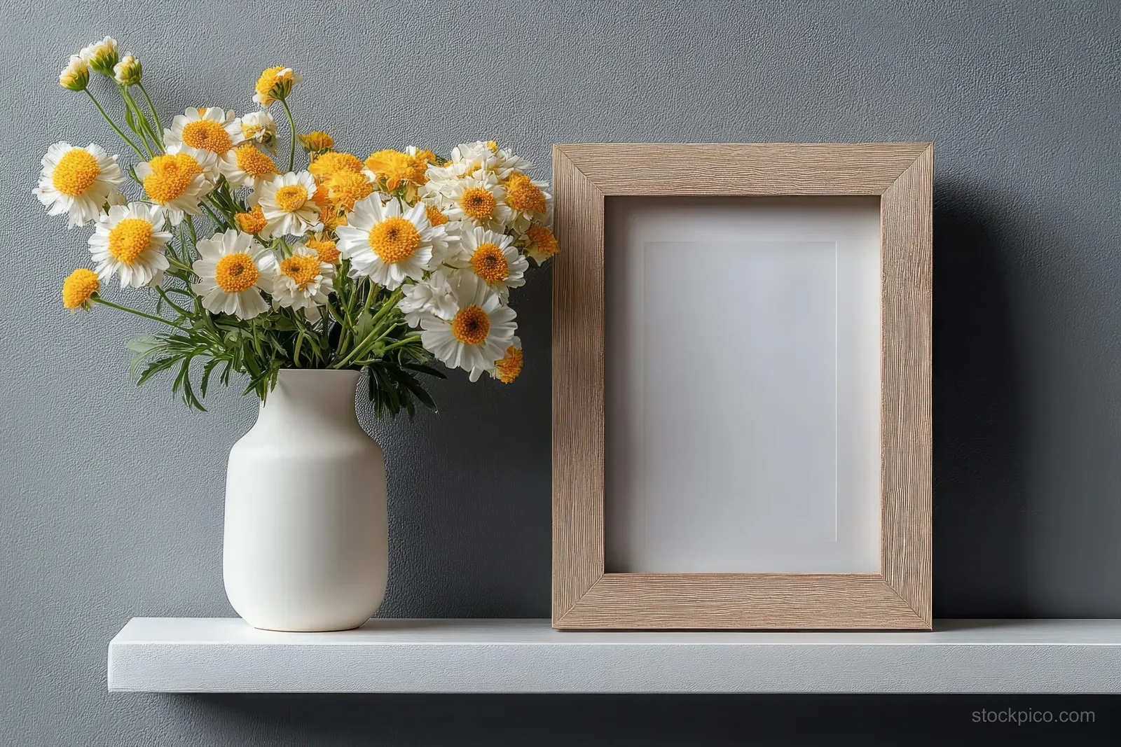 Minimalist Still Life with White Vase, Yellow Flowers, and Empty Frame on White Shelf