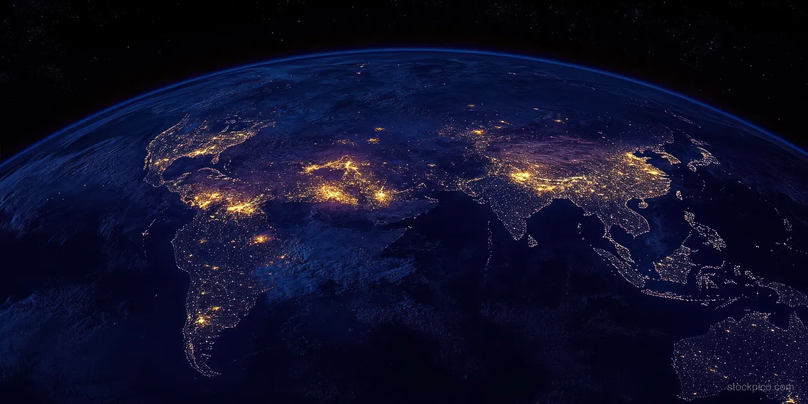 Earth viewed from space at night with glowing city lights across continents.