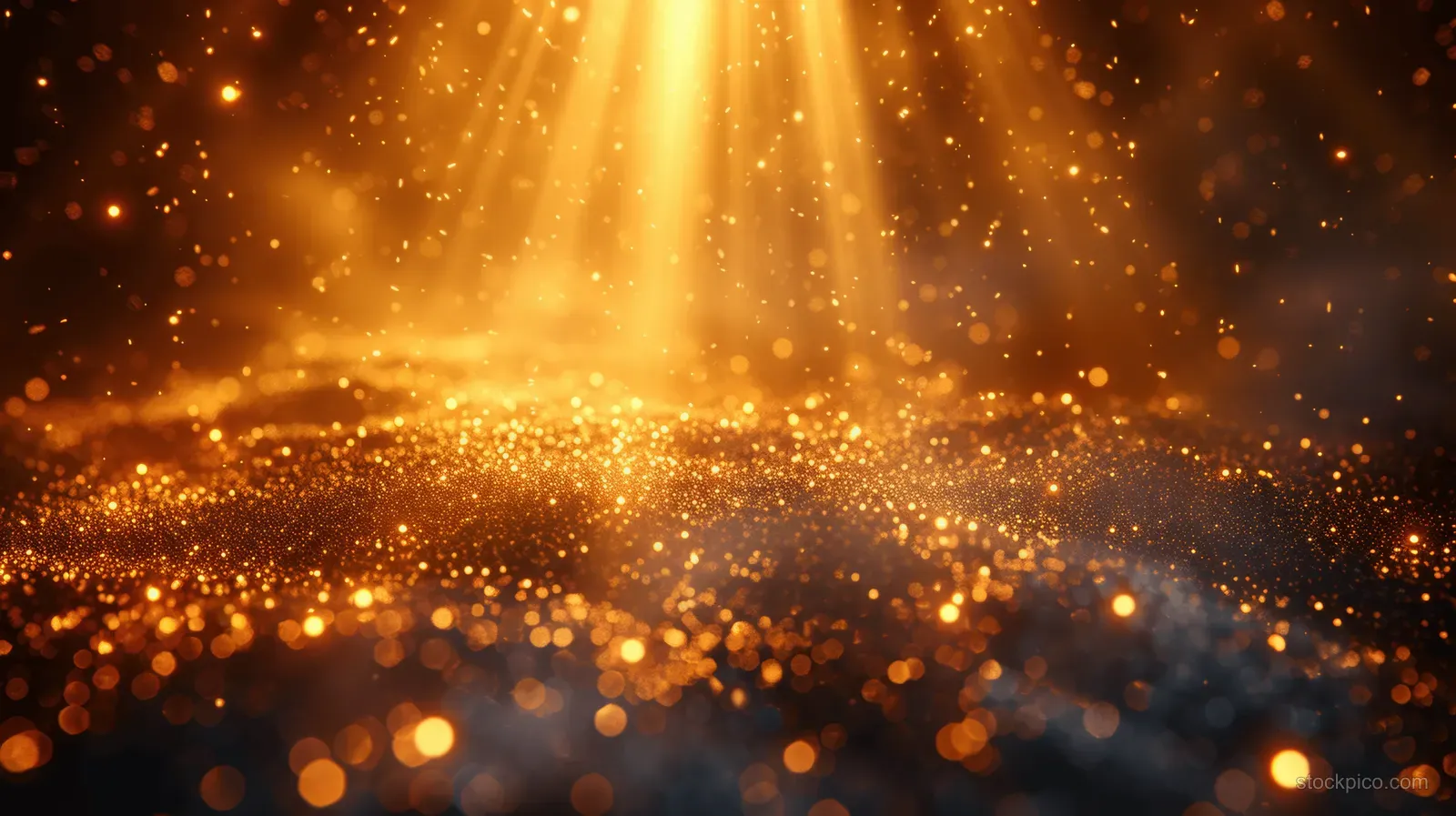 Golden starburst light flare spreads over dark bokeh particles and sparkling dust in a celebration-like background.