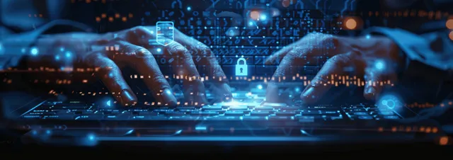 IT professional typing on laptop as glowing digital lock hovers in blue cyberspace