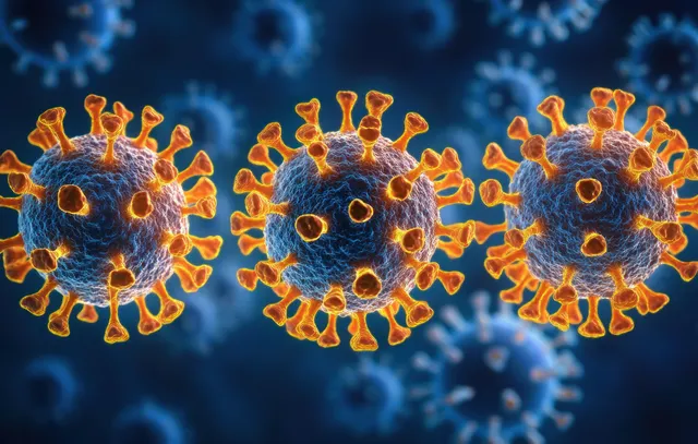 Multiple orange virus particles with glowing spikes appear against a dark blue background.