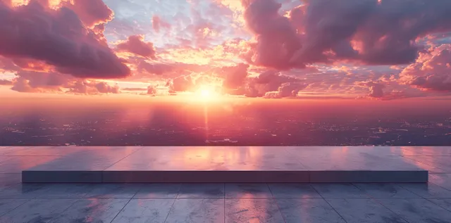 Empty concrete rooftop platform faces a sunset city skyline with bright sun flare above distant buildings.