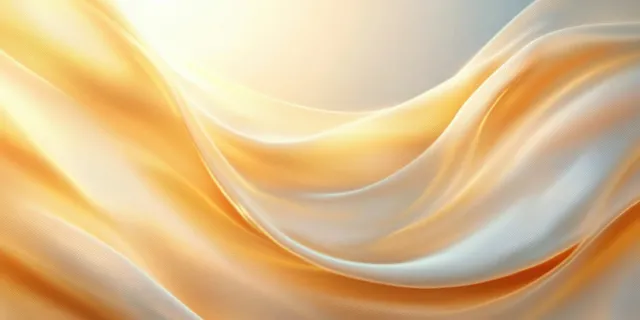 Golden satin waves flowing across a soft abstract background with gentle light reflections