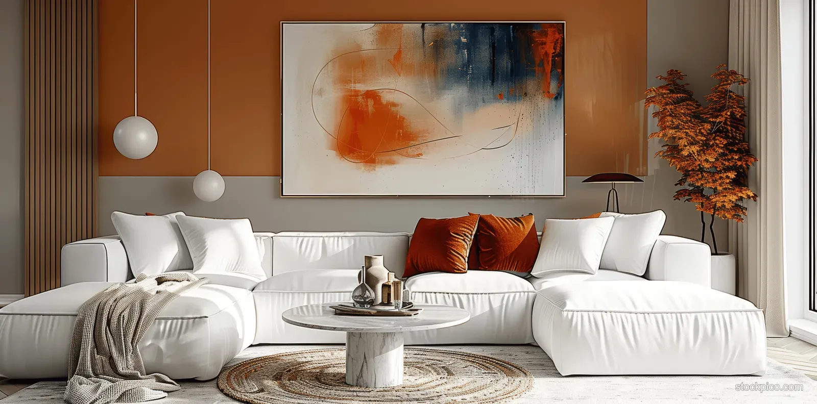 White sectional sofa with orange cushions sits in a peach living room beneath an abstract wall painting.