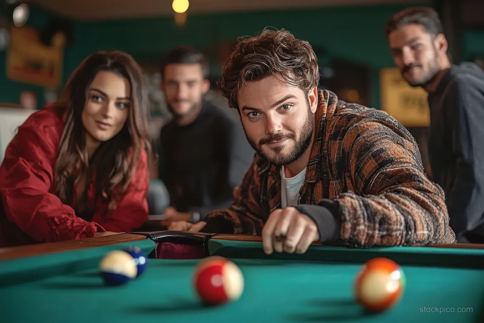 A woman aims a cue at colorful billiard balls while friends watch in a warmly lit vintage bar.