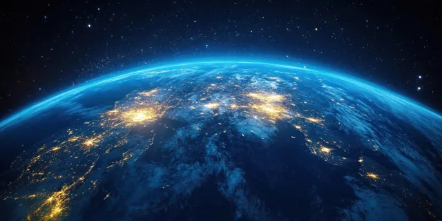 Earth at night with illuminated East Asian cities seen from space, blue orbital glow