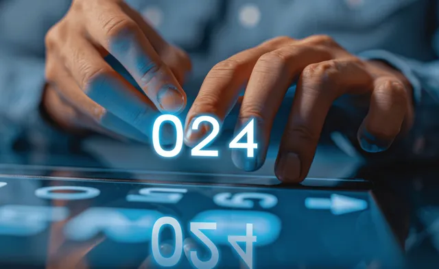 A hand interacts with a glowing virtual interface displaying a countdown for the 2024 New Year and goal setting.