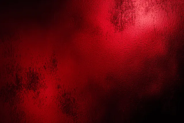 Dark red to black gradient background with soft bokeh haze and grainy dusty texture.