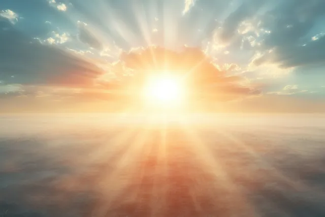 Sunrise glow bursts through misty clouds, creating radiant rays and dreamy golden haze