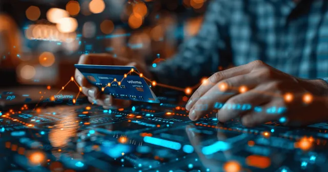 Hands interacting with a tablet as a glowing credit card and finance chart overlays appear above online shopping data.