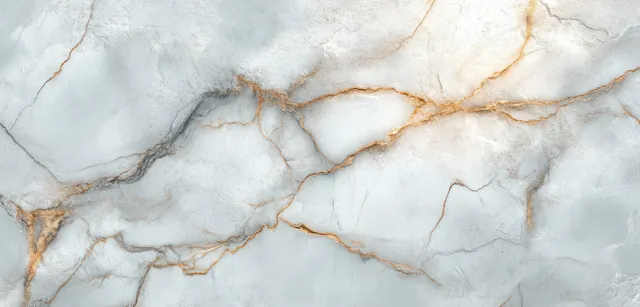Light gray marble surface with gold-brown veins and branching natural cracks.
