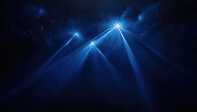 Three bright blue light beams shine through dark storm clouds in a deep night sky.