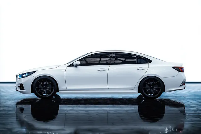 White luxury sedan side profile parked on shiny wet pavement with tinted windows, black wheels, and strong reflections.