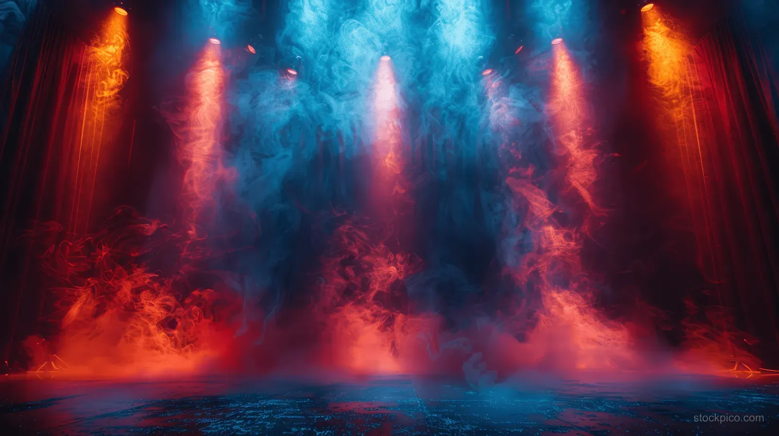 Empty concert stage with red and blue spotlights and smoky haze creating glowing light beams.